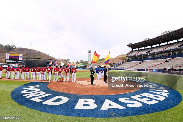 Teams stand during the national anthem prior to Game 1 of the World Baseball Classic Qualifier between Team Colombia and Team Spain at Rod Carew...