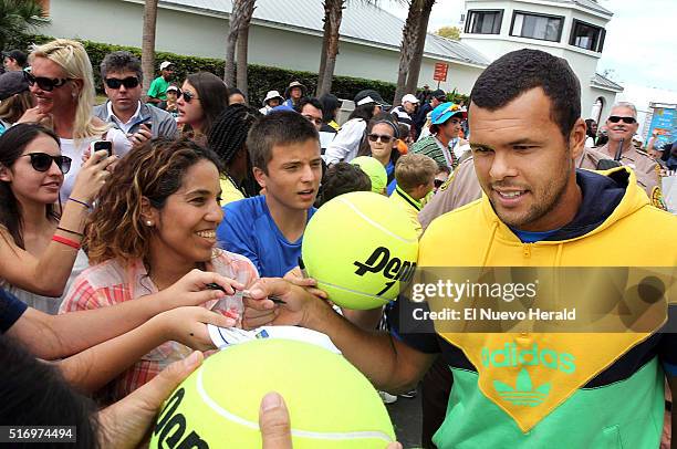 Player Jo-Wilfried Tsonga , signs autographs to fans during a media day event at the Miami Open Tennis tournament 2016, presented by Itau, in Key...