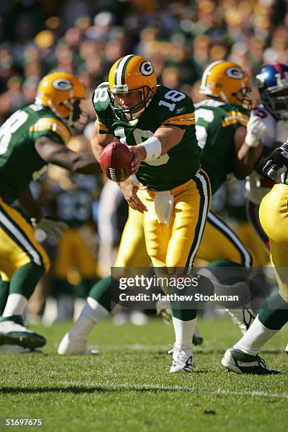 Quarterback Doug Pederson of the Green Bay Packers attempts a hand-off against the New York Giants during the game on October 3, 2004 at Lambeau...