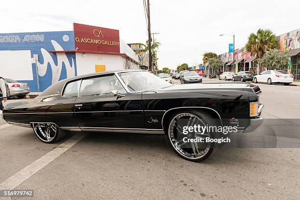 custom chevrolet impala car with drives through wynwood miami - chevrolet impala stockfoto's en -beelden