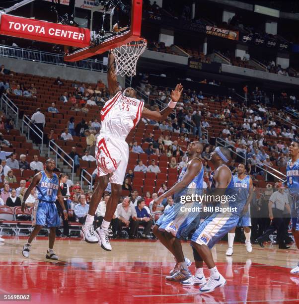 Dikembe Mutombo of the Houston Rockets shoots against the Denver Nuggets during the game at Toyota Center on October 28, 2004 in Houston, Texas. The...