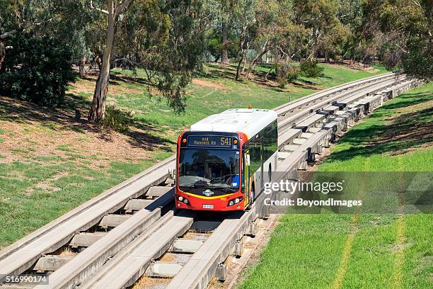 adelaide metro bus travelling along o-bahn guided busway - adelaide stock pictures, royalty-free photos & images