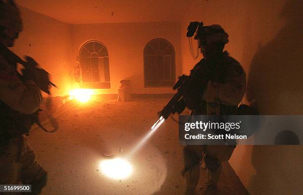 Army soldiers from the 1st Infantry Division's 2nd Battalion-2nd Regiment sweep through an abandoned home during heavy fighting November 9, 2004 in...