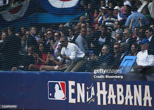 Cuban President Raul Castro, from front center, U.S. President Barack Obama, first lady Michelle Obama, Sasha Obama, and Malia Obama applaud during...