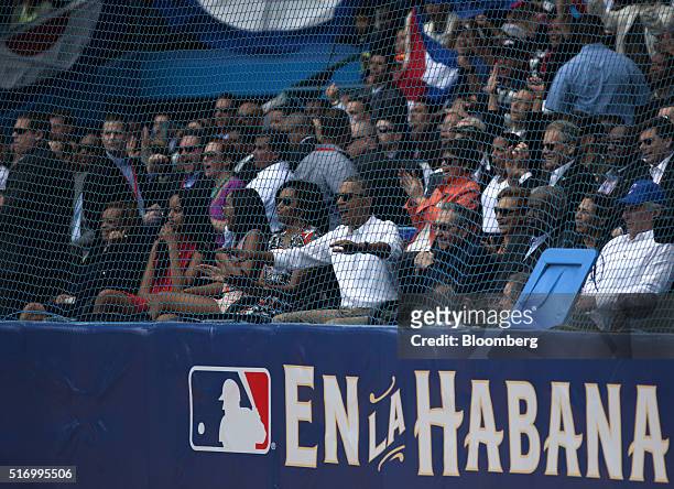 Cuban President Raul Castro, from front center, U.S. President Barack Obama, first lady Michelle Obama, Sasha Obama, and Malia Obama watch an...