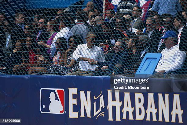 President Barack Obama, center left, shakes hands with Cuban President Raul Castro, center right, as first lady Michelle Obama, Sasha Obama, and...