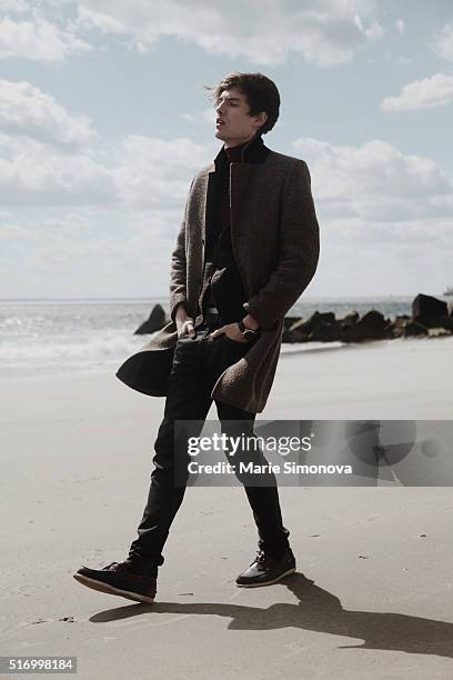 Michael Shmatov wearing H&M coat, Gap turtleneck and Levi's trousers seen on March 21, 2016 in Coney Island, New York City.