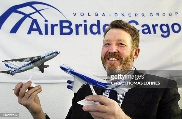 The president of the Russian Volga-Dnepr Group, Alexej Isaikin, holds models of his company's airplanes as he presents the subsidiary company...