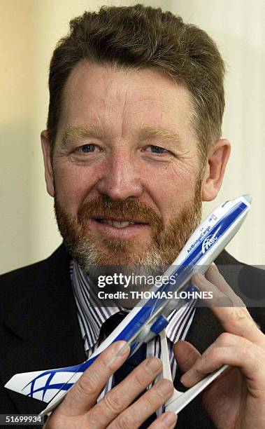 The president of the Russian Volga-Dnepr Group, Alexej Isaikin, holds a model of his company's airplanes as he presents the subsidiary company...