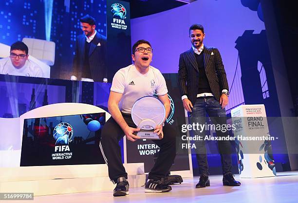 Mohamad Al-Bacha of Denmark celebrates with the trophy presented by David Villa of New York City FC after defeating Sean Allen of England during the...