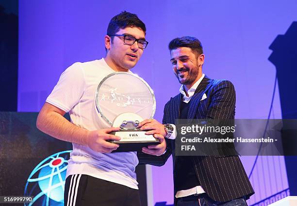 Mohamad Al-Bacha of Denmark celebrates with the trophy presented by David Villa of New York City FC after defeating Sean Allen of England during the...