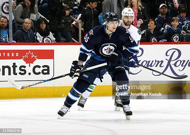 Mark Scheifele of the Winnipeg Jets and Chris Higgins of the Vancouver Canucks keep an eye on the play during first period action at the MTS Centre...