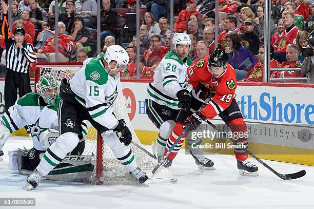 Jonathan Toews of the Chicago Blackhawks chases the puck against Patrik Nemeth and Cody Eakin of the Dallas Stars in the second period of the NHL...