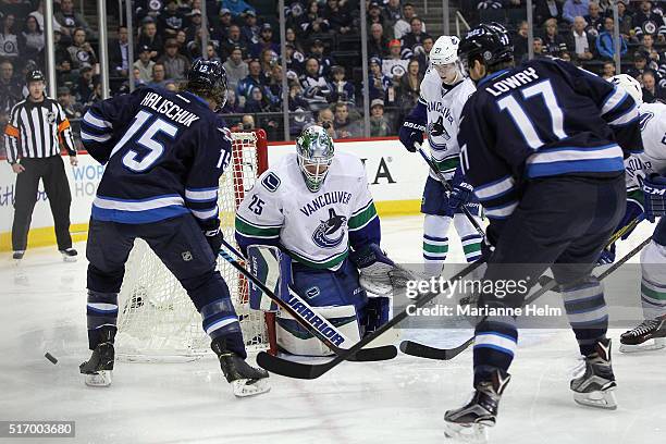 Jacob Markstrom of the Vancouver Canucks protects his net in front of Matt Halischuk of the Winnipeg Jets in second period action in an NHL game at...