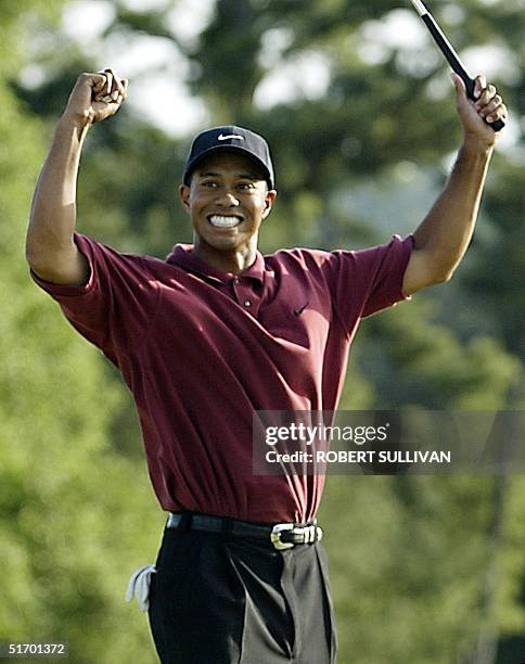Tiger Woods of the US celebrates on the 18th hole 14 April 2002, after winning the 2002 Masters golf tournament at the Augusta National Golf Club in...