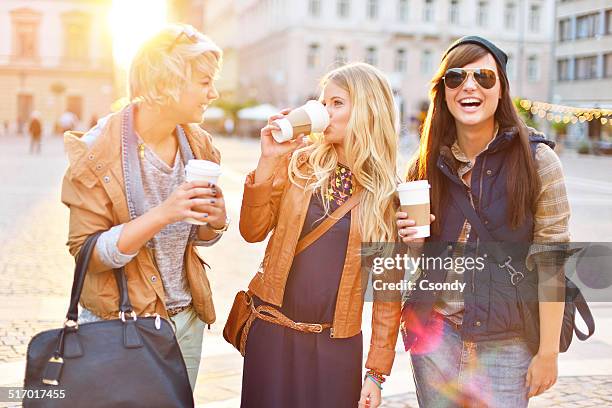 young friends together drinking coffee in the city - coffe to go stockfoto's en -beelden