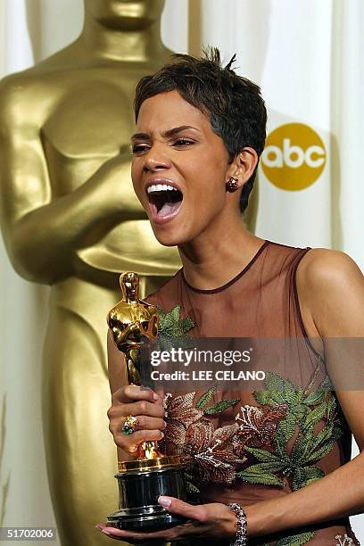Actress Halle Berry holds the Oscar statue after winning the award for best actress in a leading role for her portrayal of Leticia Musgrove, a woman...