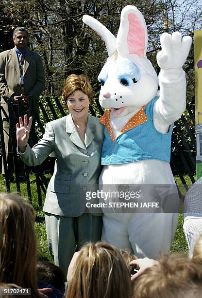 First Lady Laura Bush along with the Easter Bunny wave during the annual Easter Egg Roll on the South Lawn of the White House 1 April 2002. Earlier...