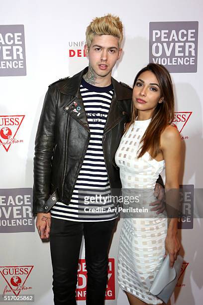 Singer Travis Mills and Michele Maturo attend the GUESS Foundation and Peace Over Violence Denim Day Cocktail Event at at MOCA Grand Avenue on March...