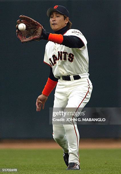 San Francisco Giants' Tsuyoshi Shinjo of Japan catches a pop-up from San Diego Padres' Deivi Cruz 05 April 2002 in San Francisco. The Giants defeated...