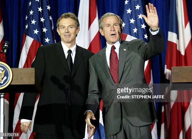 President George W. Bush and British Prime Minister Tony Blair wave after their joint press conference at Crawford High School 06 April 2002 in...