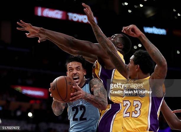 Matt Barnes of the Memphis Grizzlies drives to the basket against Louis Williams and Brandon Bass of the Los Angeles Lakers during the second half of...