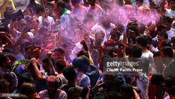 People play with colors in celebration of Holi festival to mark the beginning of spring season.