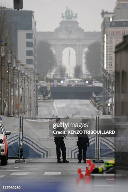 Belgian police officers stand guard near Maelbeek - Maalbeek subway station in Brussels on March 23 a day after triple bomb attacks in the Belgian...