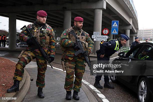 Belgian soldiers stand guard as police check vehicles outside of the closed Brussels Zaventem airport on March 23, 2016 in Brussels, Belgium. Belgium...