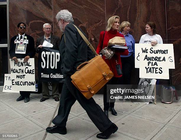 Andria Pia Yates' defense attorney George Parnham reads a protester's sign outside Harris County Courthouse during the lunch break at the punishment...