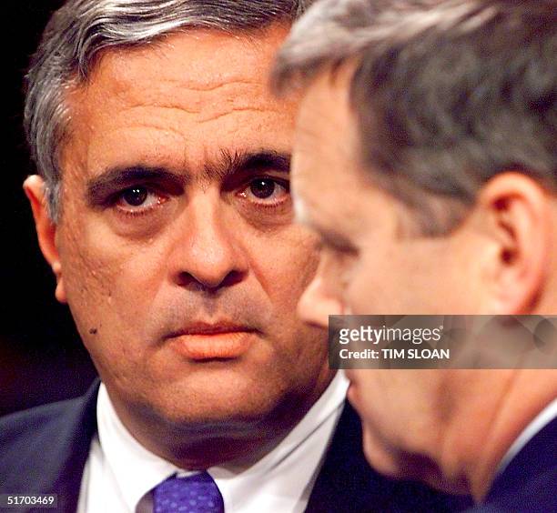 Director George Tenet talks to Vice Admiral Thomas Wilson , Director Defense Intelligence Agency, before a Senate Armed Services Committee hearing on...