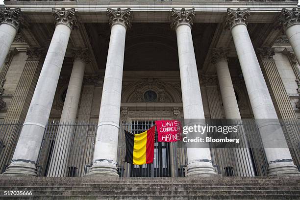 The national flag of Belgium hangs between columns outside the Brussels stock exchange, operated by Euronext NV, in Brussels, Belgium, on Wednesday,...