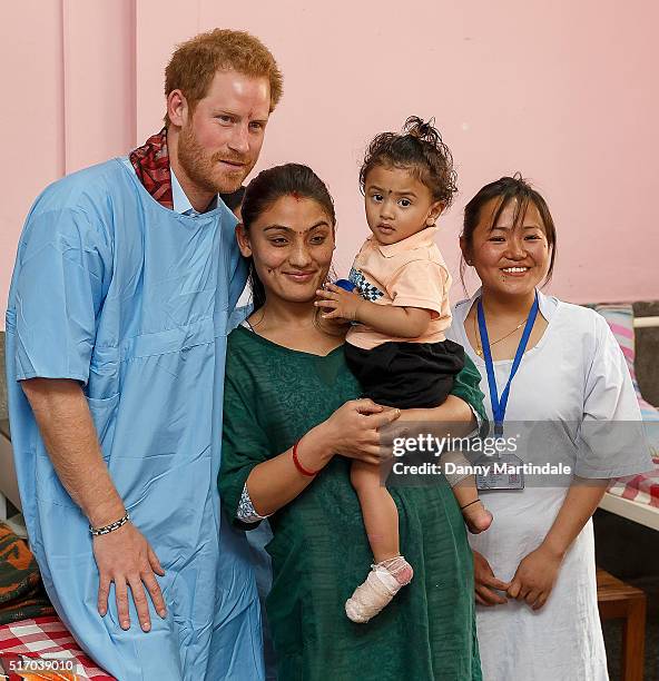 Prince Harry poses with staff and patients as he visits Kanti Children's Hospital where he spent time with young people being treated with burns on...