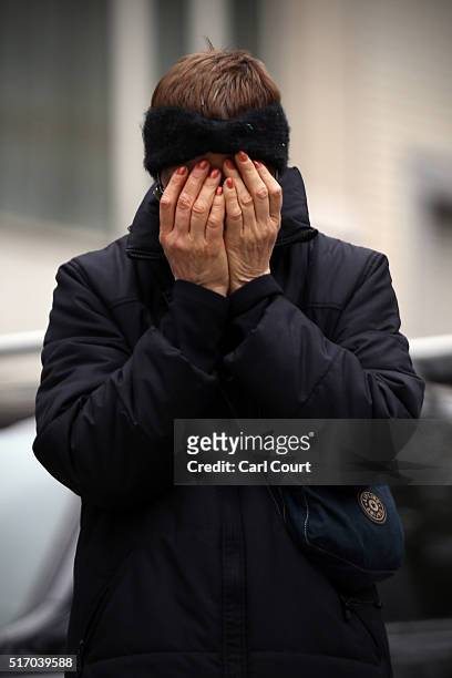 Woman covers her face near Maelbeek metro station as she reacts following yesterday's attack, on March 23, 2016 in Brussels, Belgium. Belgium is...