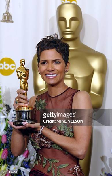 Actress Halle Berry holds her Oscar after winning the award for best actress in a leading role for her portrayal of Leticia Musgrove, a woman...
