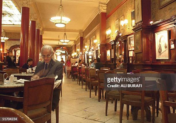 Man is seen eating at "Tortoni" cafe, the oldest restaurant in Buenos Aires, Argentina 01 March 2002. Un hombre lee un diario en el antiguo cafe...