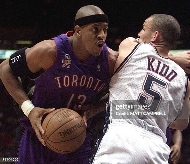 Toronto Raptors' forward Jerome Williams pulls the ball away from New Jersey Nets' guard Jason Kidd in the first quarter 12 March 2002 at Continental...