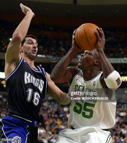 Eric Williams of the Boston Celtics goes head-to-head with Predraj Stojakovic of the Sacramento Kings on his way to the basket during the first...