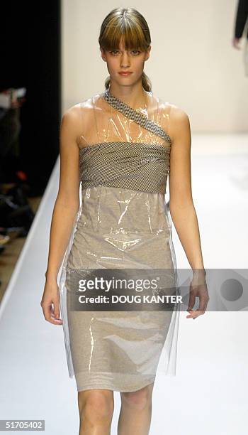 Model wears a grey t-shirt strapless dress, plastic sheath and black gingham obi sash at the Wink Fall 2002 fashion show in New York 12 February...