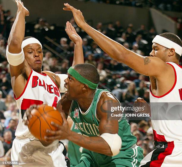 Boston Celtics Eric Williams is surrounded by Portland Trail Blazers Bonzi Wells and Rasheed Wallace during the first quarter of their NBA game in...