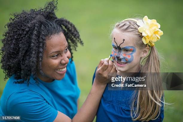 little girl getting her face painted - face paint stock pictures, royalty-free photos & images