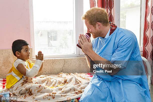 Prince Harry meets young burns victim Biplov Puri, 4 at Kanti Children's Hospital on the final day of his tour of the country on March 23, 2016 in...