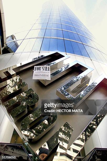 Sign reading advertising a website and reading "For Sale" is taped onto the Enron logo at the entrance of Enron headquarters in Houston, Texas 26...