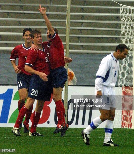 United States players Ante Razov and Eddie Lewis celebrate with Brian McBride after McBride scored against El Salvador during the quarterfinal match...