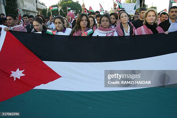 Jordanian Princess Aya al-Faisel , Princess Rym al-Ali and Princess Aisha bint al-Hussein join a rally outside the Grand Hyatt hotel, one of the...