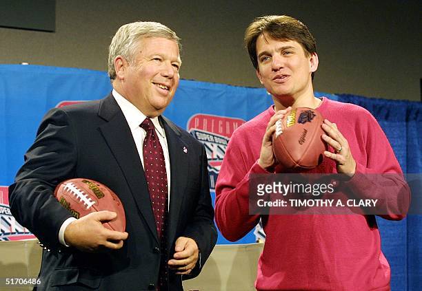 Boston Pops Orchestra Conductor Keith Lockhart and New England Patriots owner Robert Kraft pose with a football during a press conference 31 January...