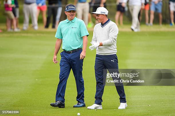 Jason Dufner and Rickie Fowler smile while talking on the first hole fairway during the first round of the World Golf Championships - Dell Match Play...