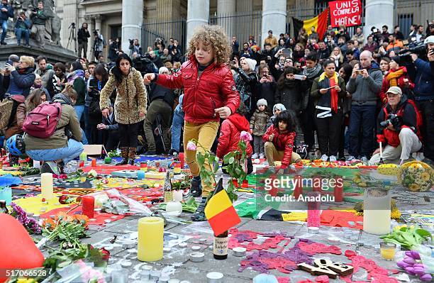 People gather at Place de la Bourse to commemorate yesterday's multiple terrorist attack victims in Brussels, Belgium on March 23, 2016. Tuesdays...