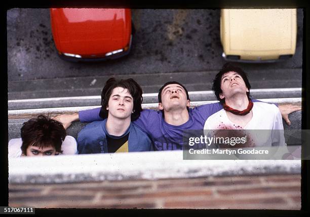 Group portrait of the Manic Street Preachers, leaning out of the window of Martyn Goodacre's flat, Old Kent Road, London, January 1991. L-R Nicky...