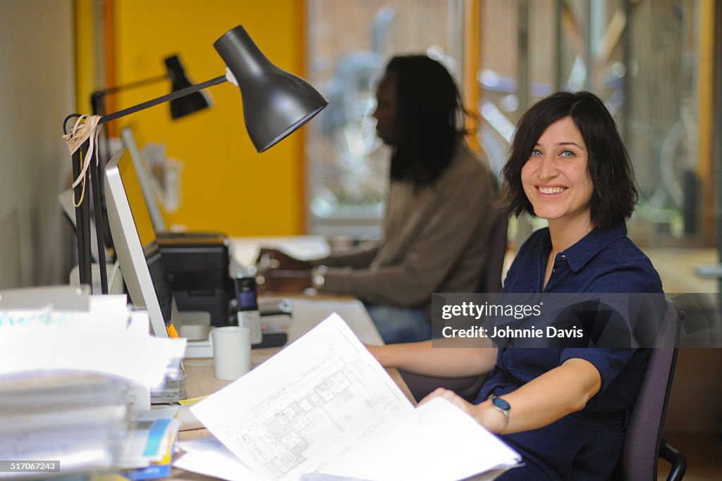 Female architect working at desk in home office